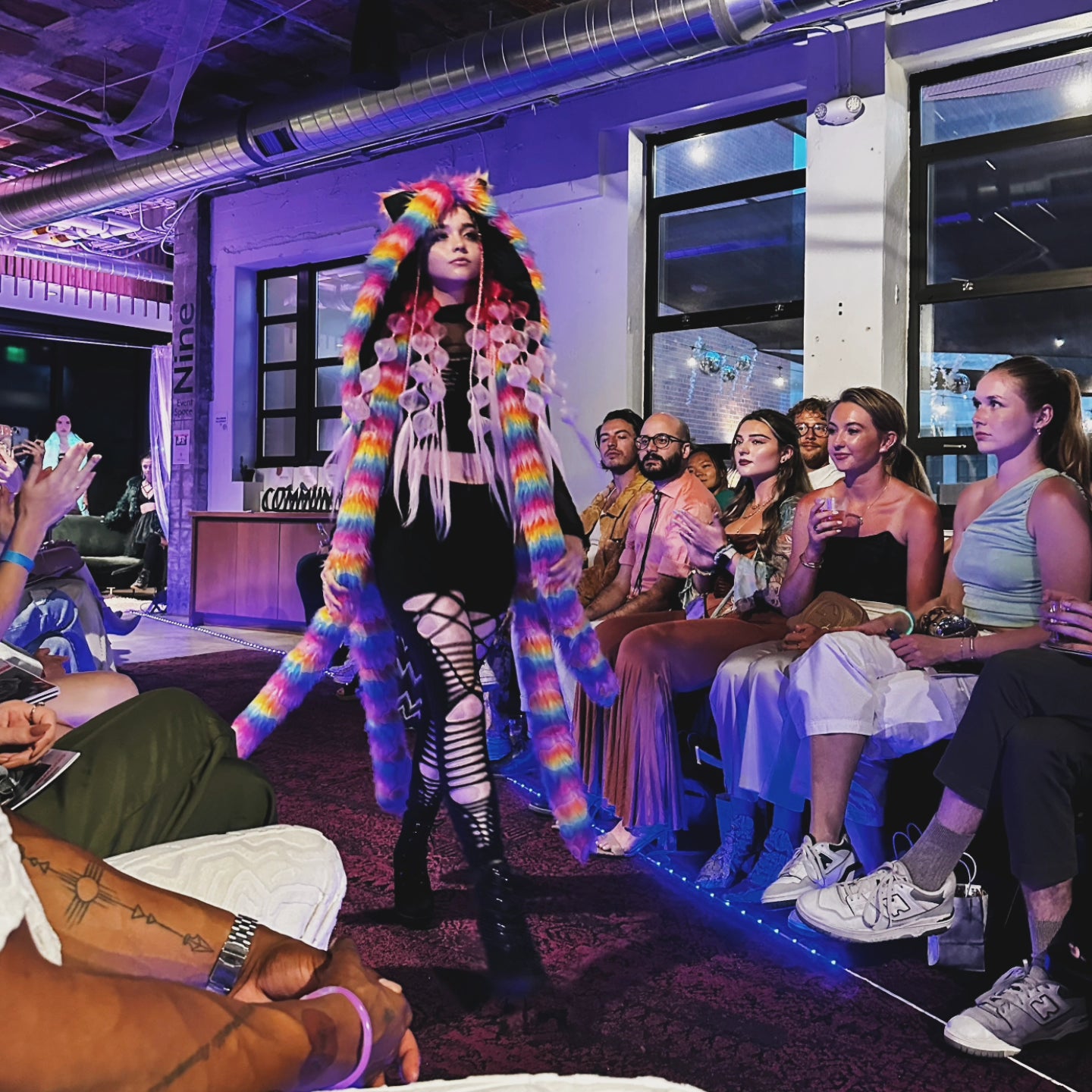 Model wearing rainbow tentacle hood at fashion show