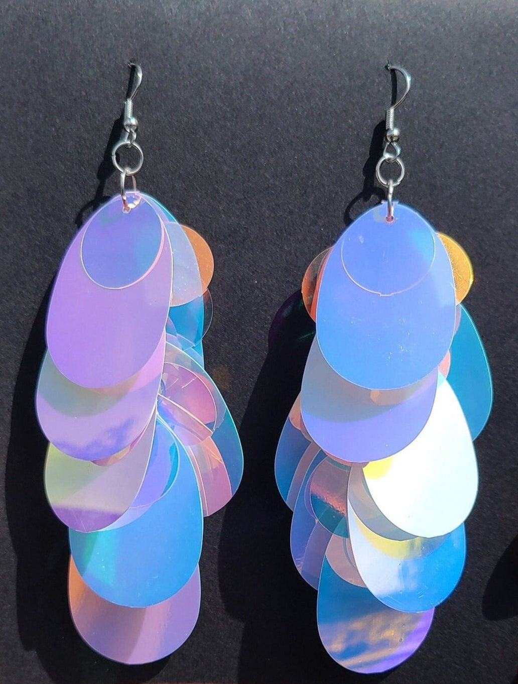 Blue iridescent teardrop shaped sequin earrings with silver hardware.