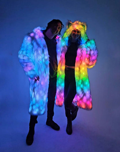 Two people wearing colorful LED outfits against a dark background