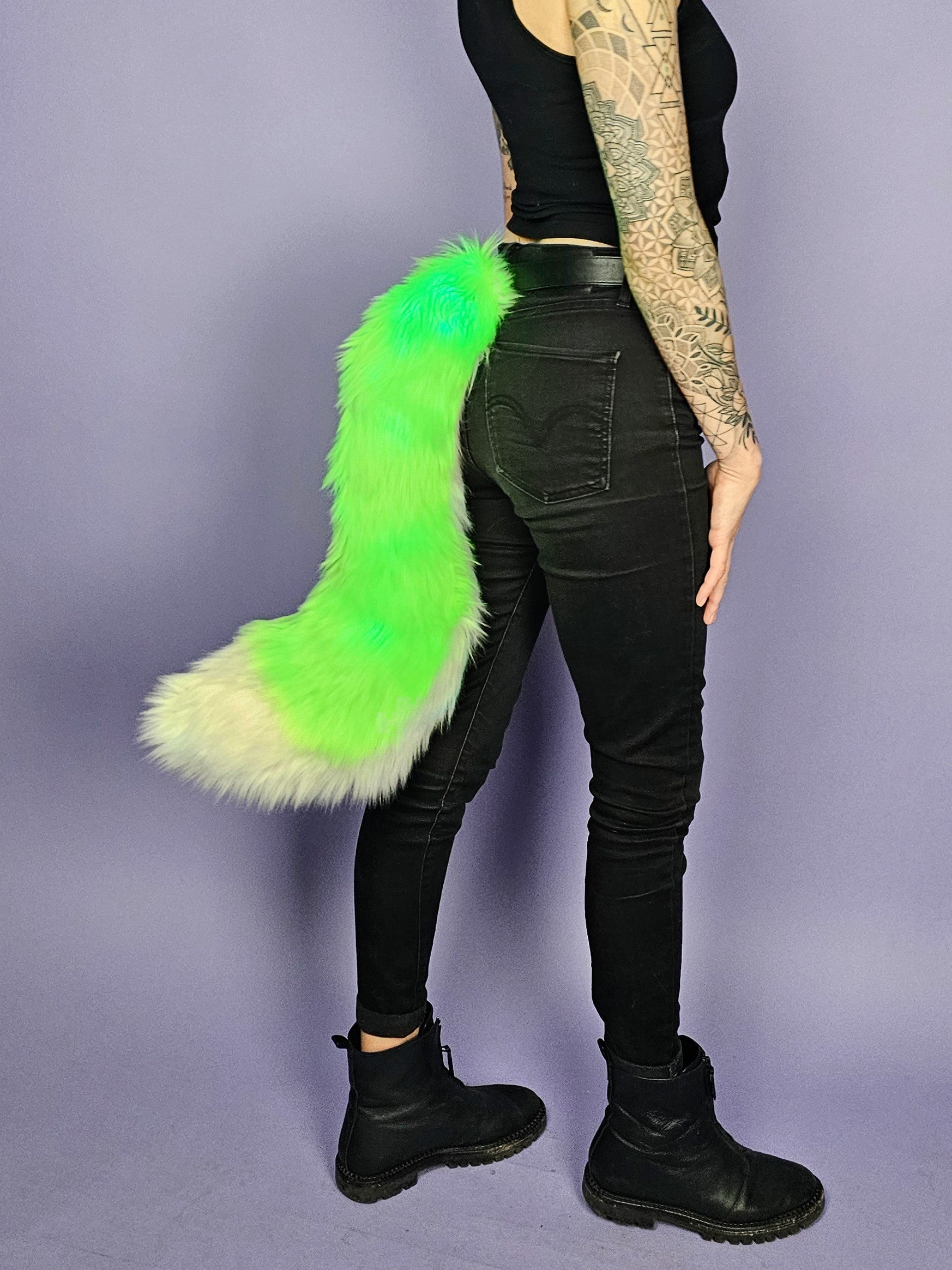 Large dynamic shape faux fur tail with green and white fur.