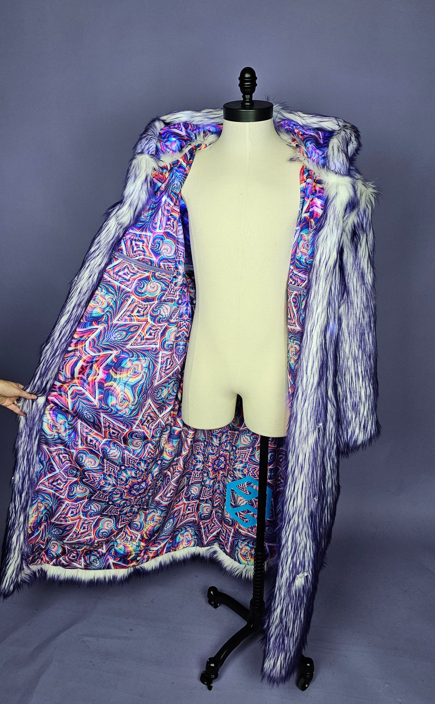 Purple faux fur coat with colorful psychedelic lining.