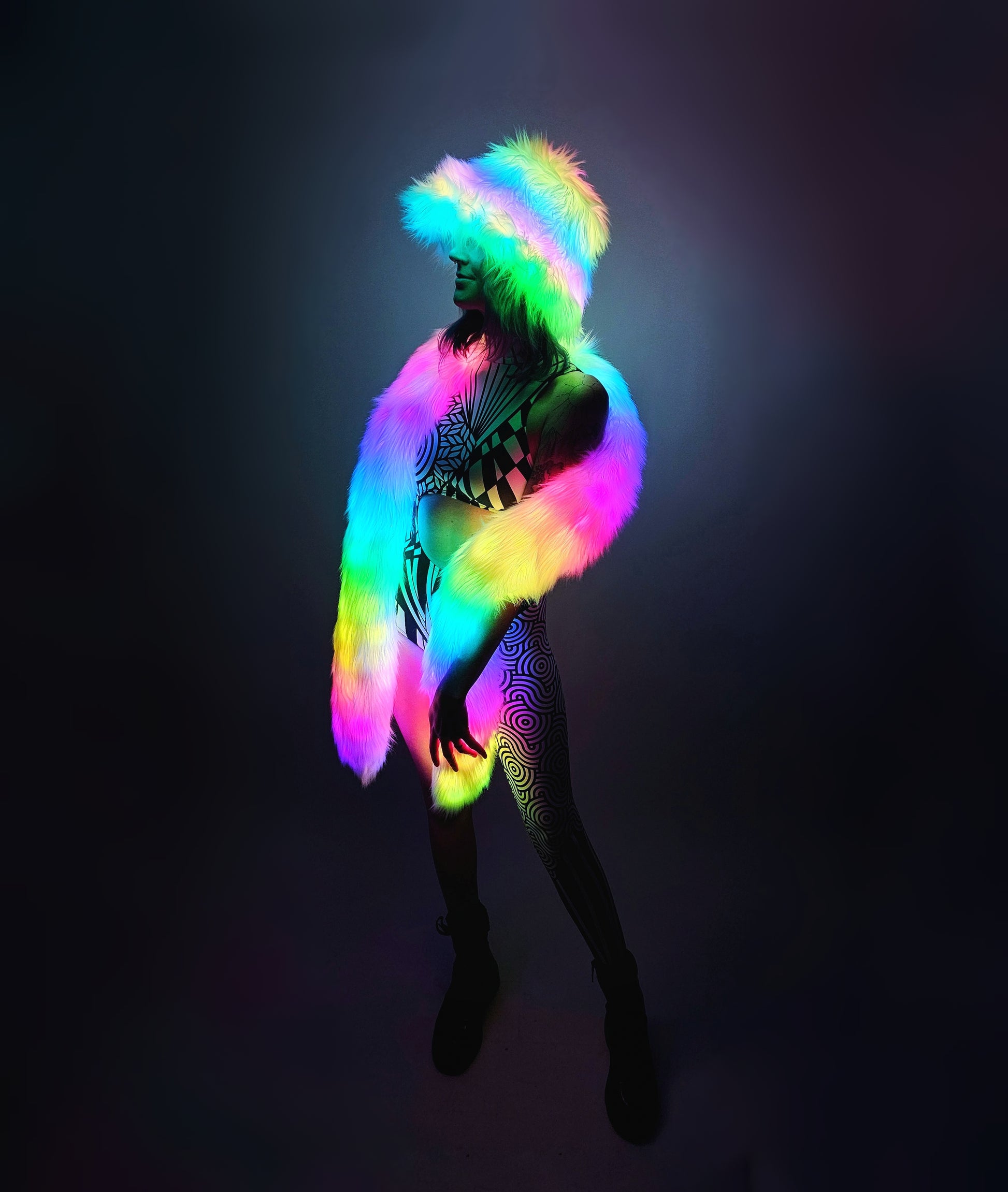 Woman wearing LED faux fur bucket hat and scarf with rainbow lights