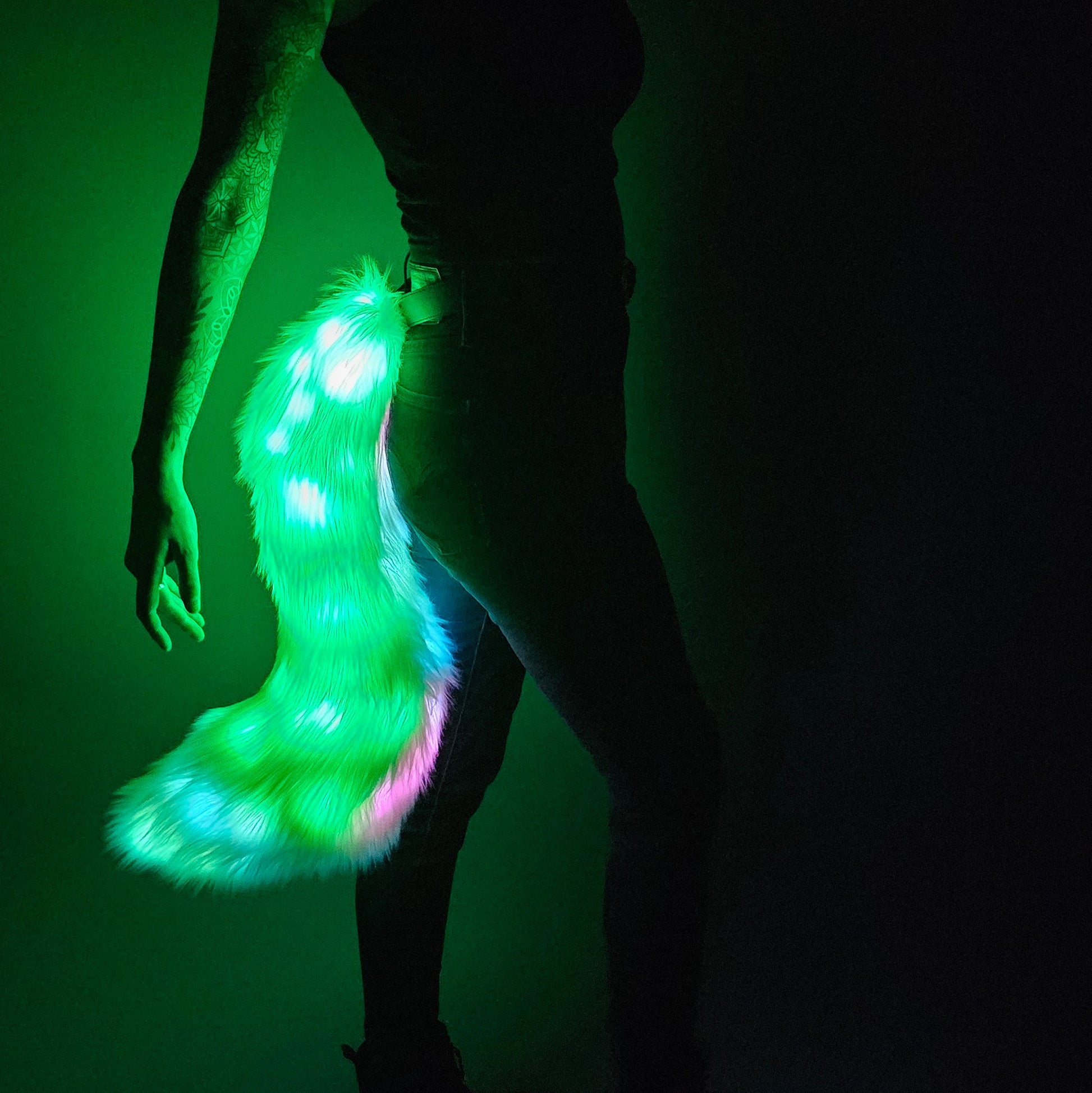 Green and white faux fur tail with LEDs.