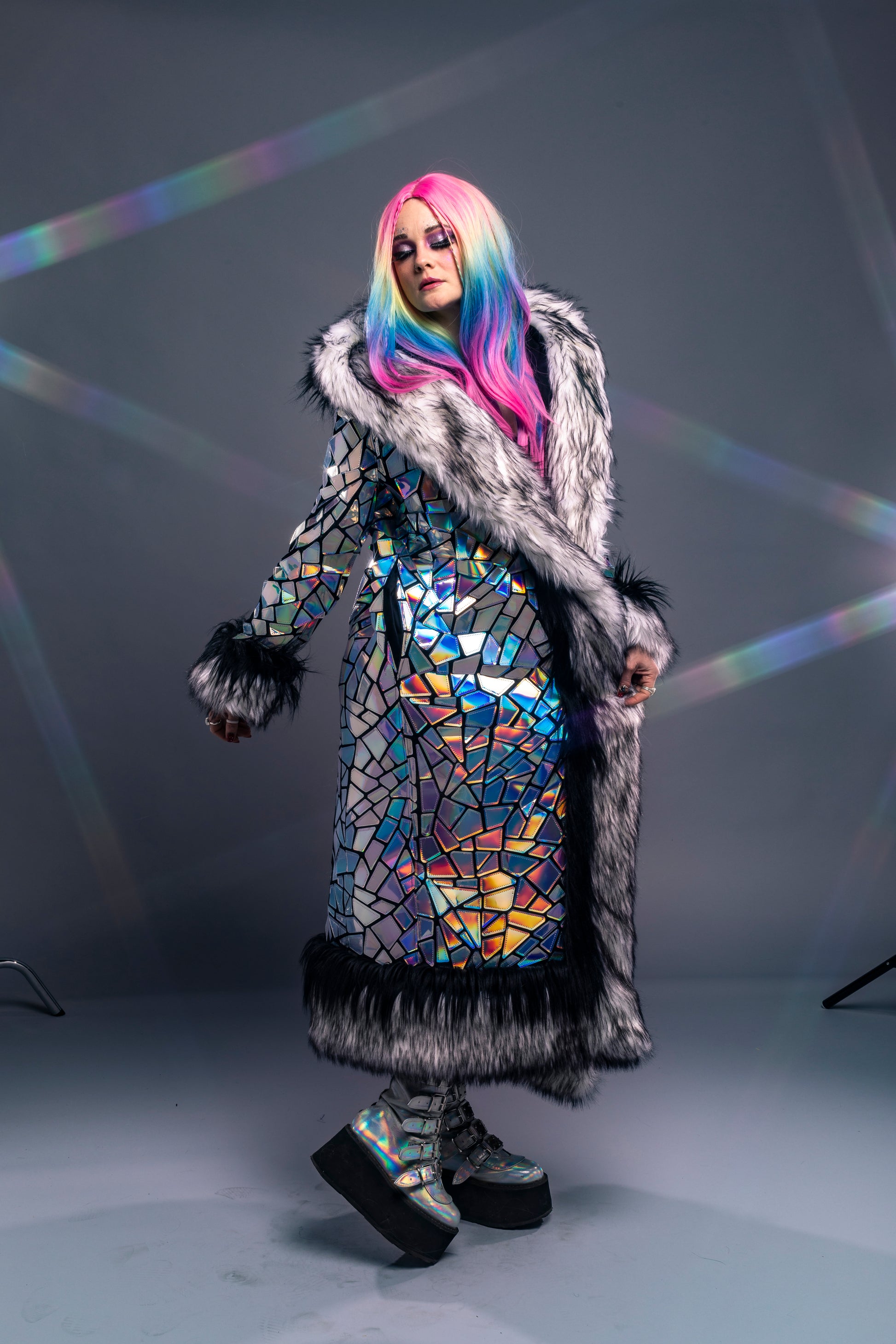 model wearing silver holographic coat with LED fur trim