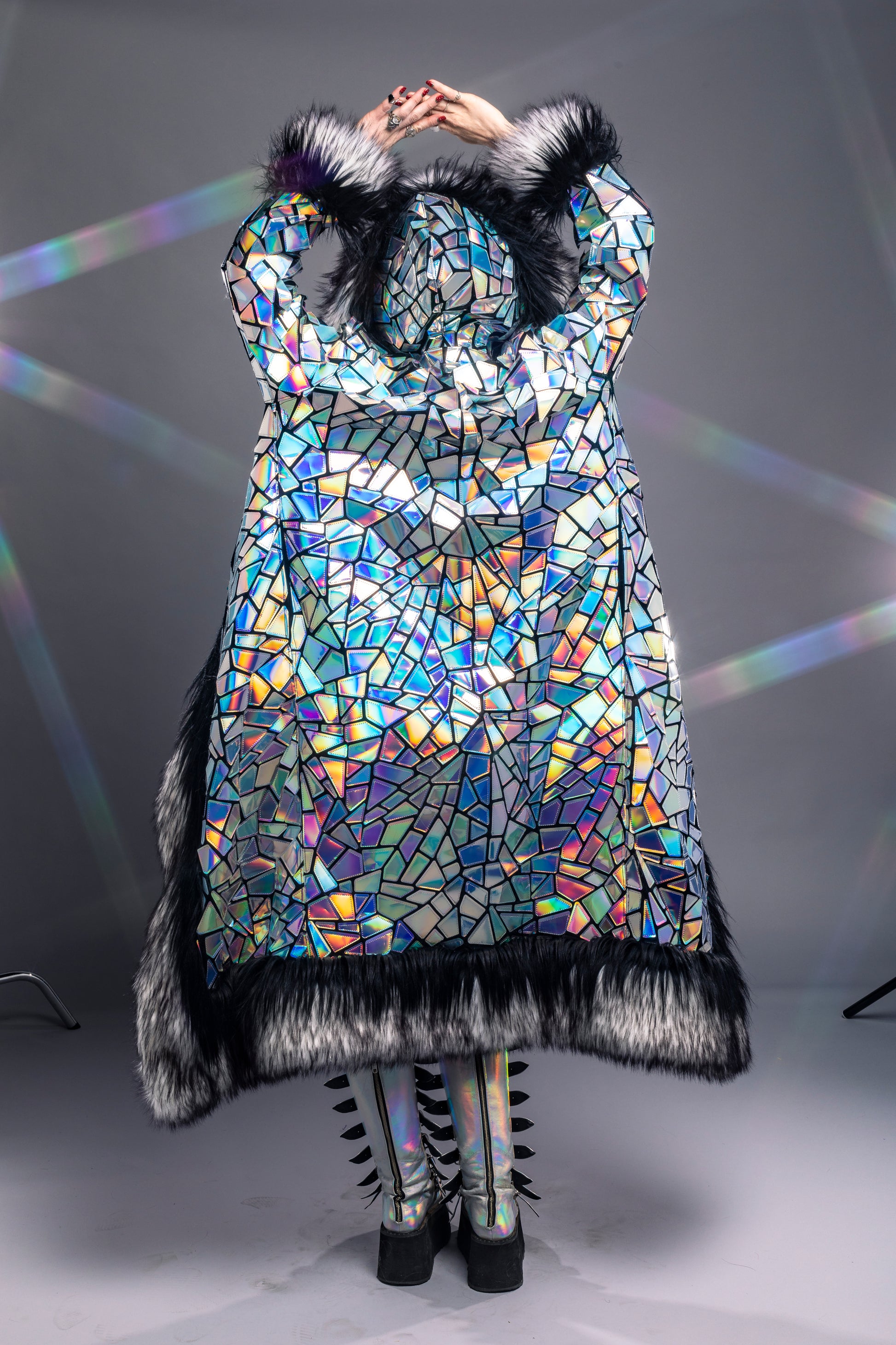 model wearing silver holographic coat with LED fur trim