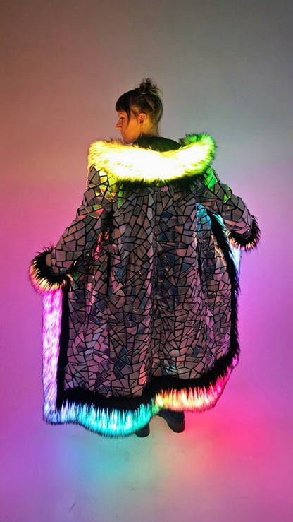 Person wearing a colorful, illuminated coat with a gradient background