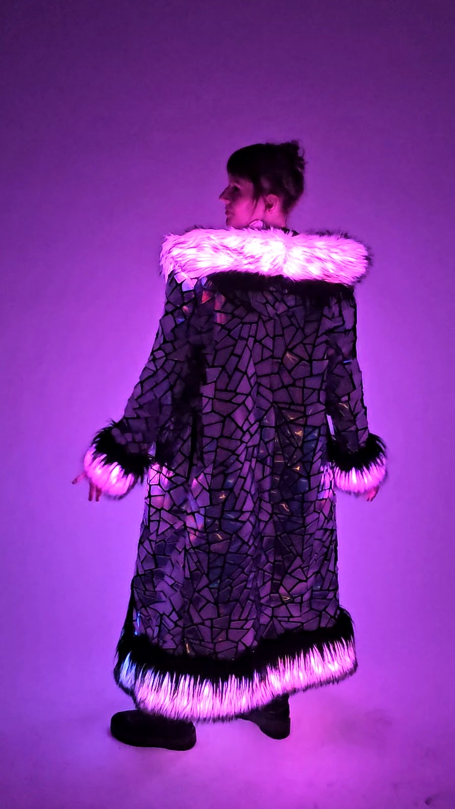 Person wearing holographic coat with LED lights