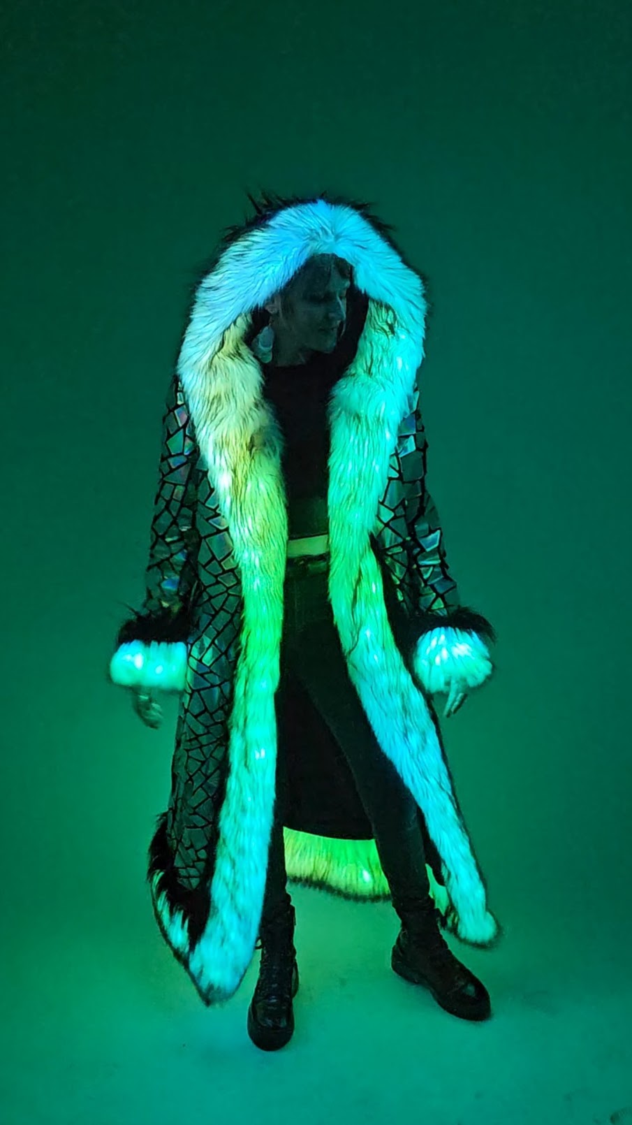 Person wearing long coat with green LED trim