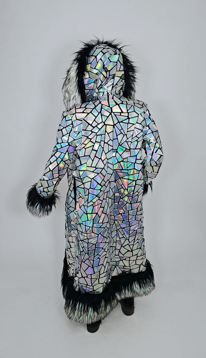Iridescent mosaic-patterned coat with fur trim on a plain background