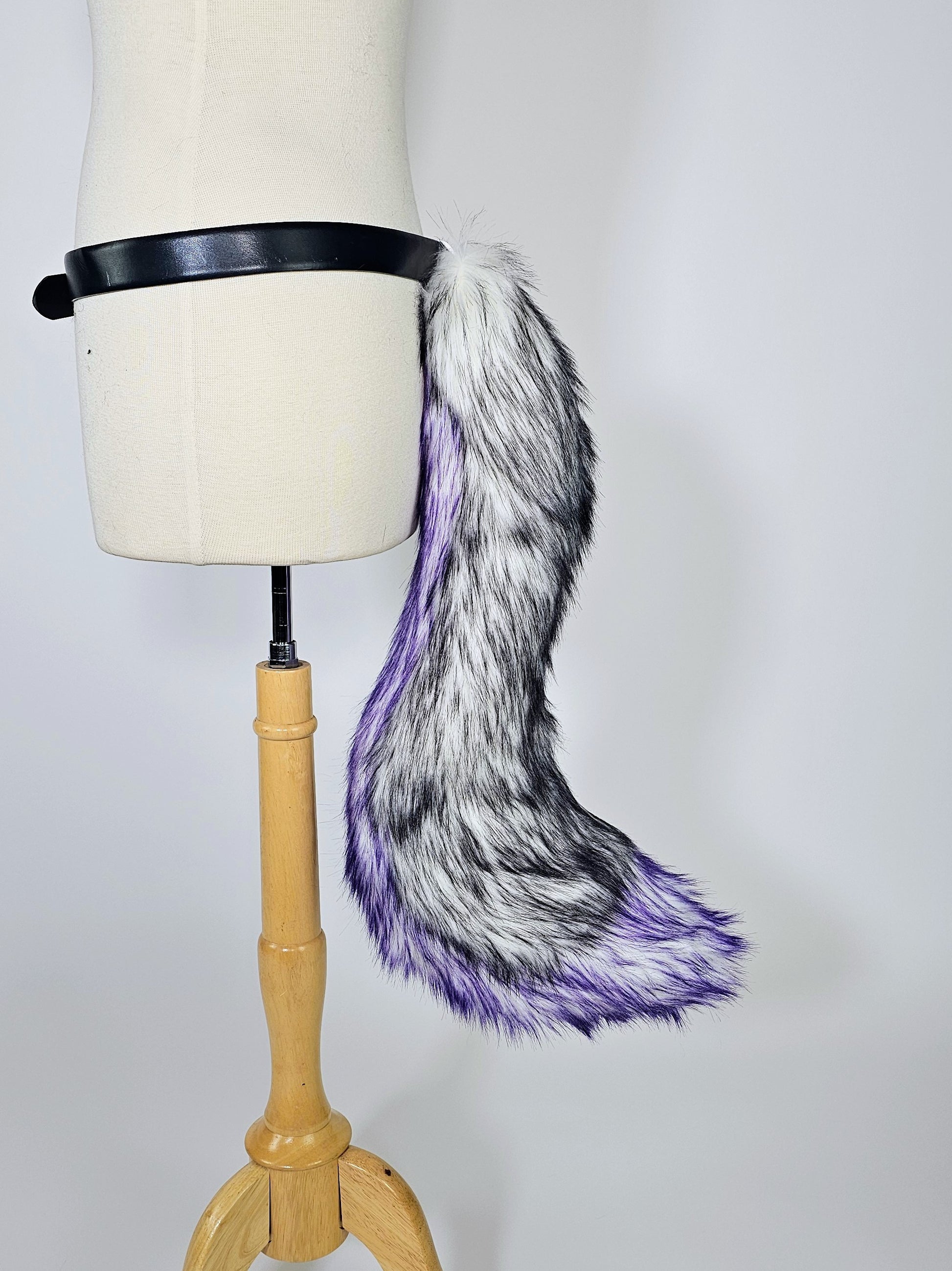 Mannequin wearing LED tail with black and purple faux fur