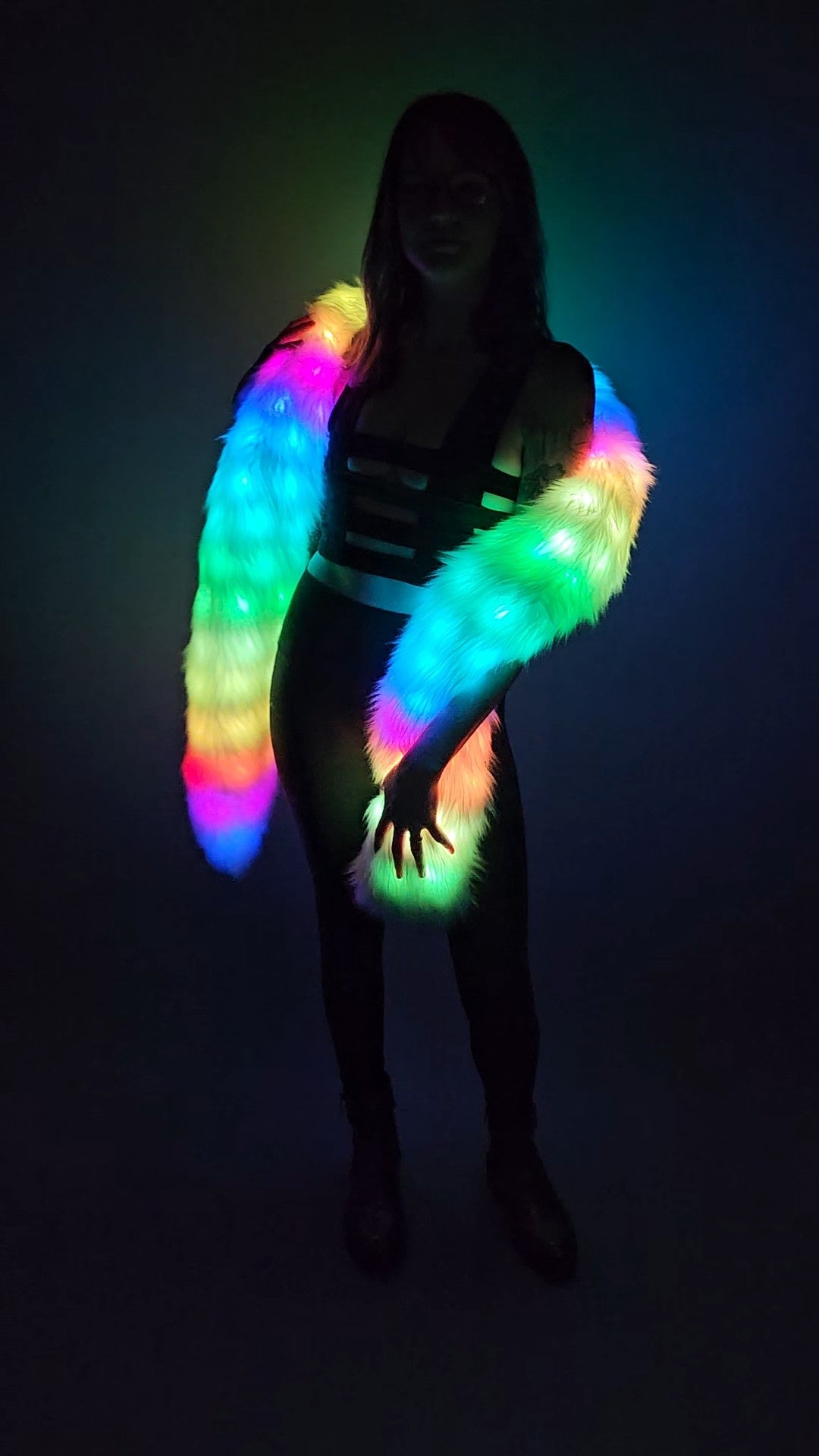 Woman wearing a white faux fur Glow Worm scarf with multicolor LEDs.