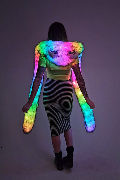 Person wearing a colorful, glowing hood against a dark background