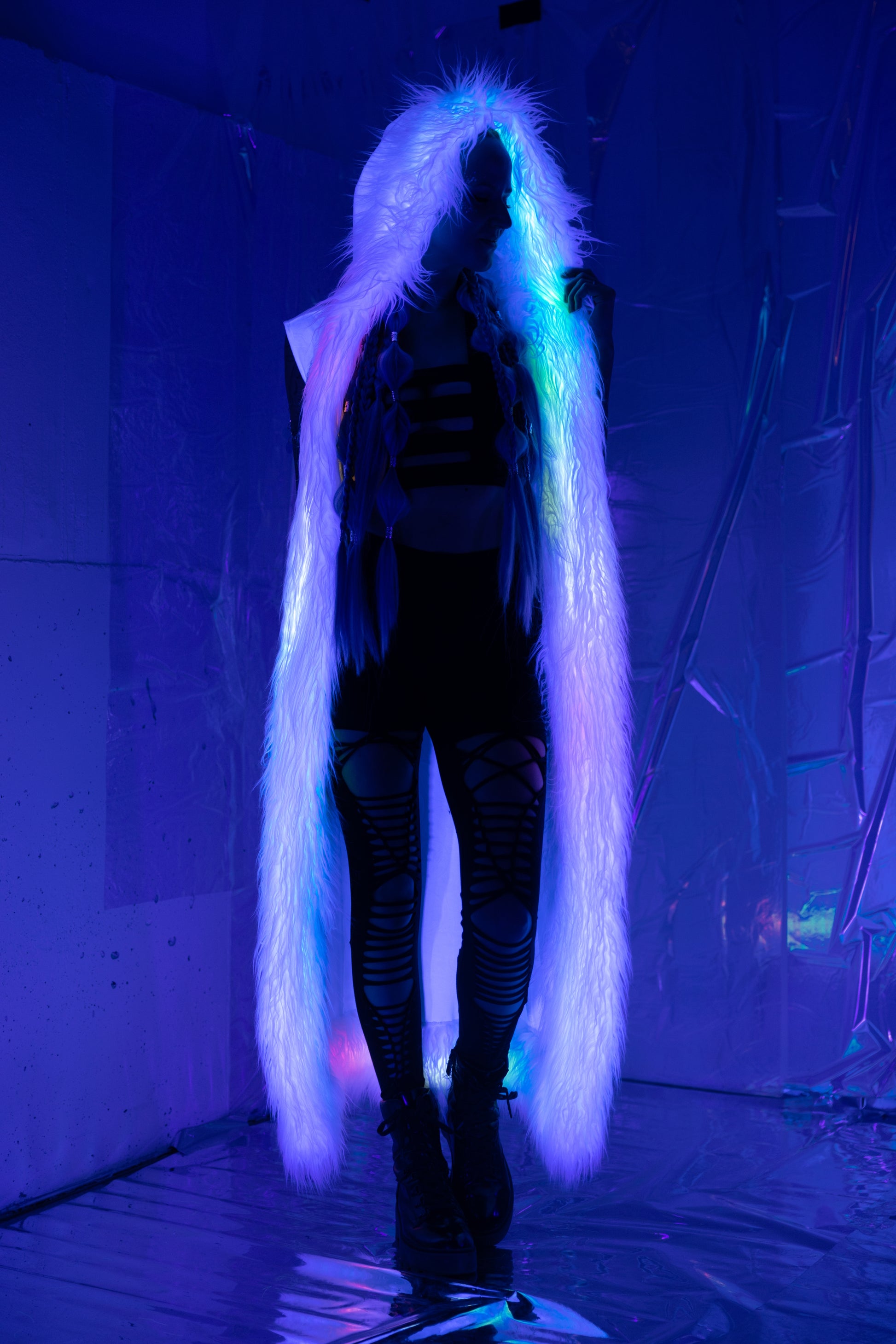 Long white velvet duster vest with white faux fur trim viewed with blacklight.