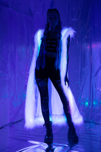 Long white velvet duster vest with white faux fur trim viewed with blacklight.