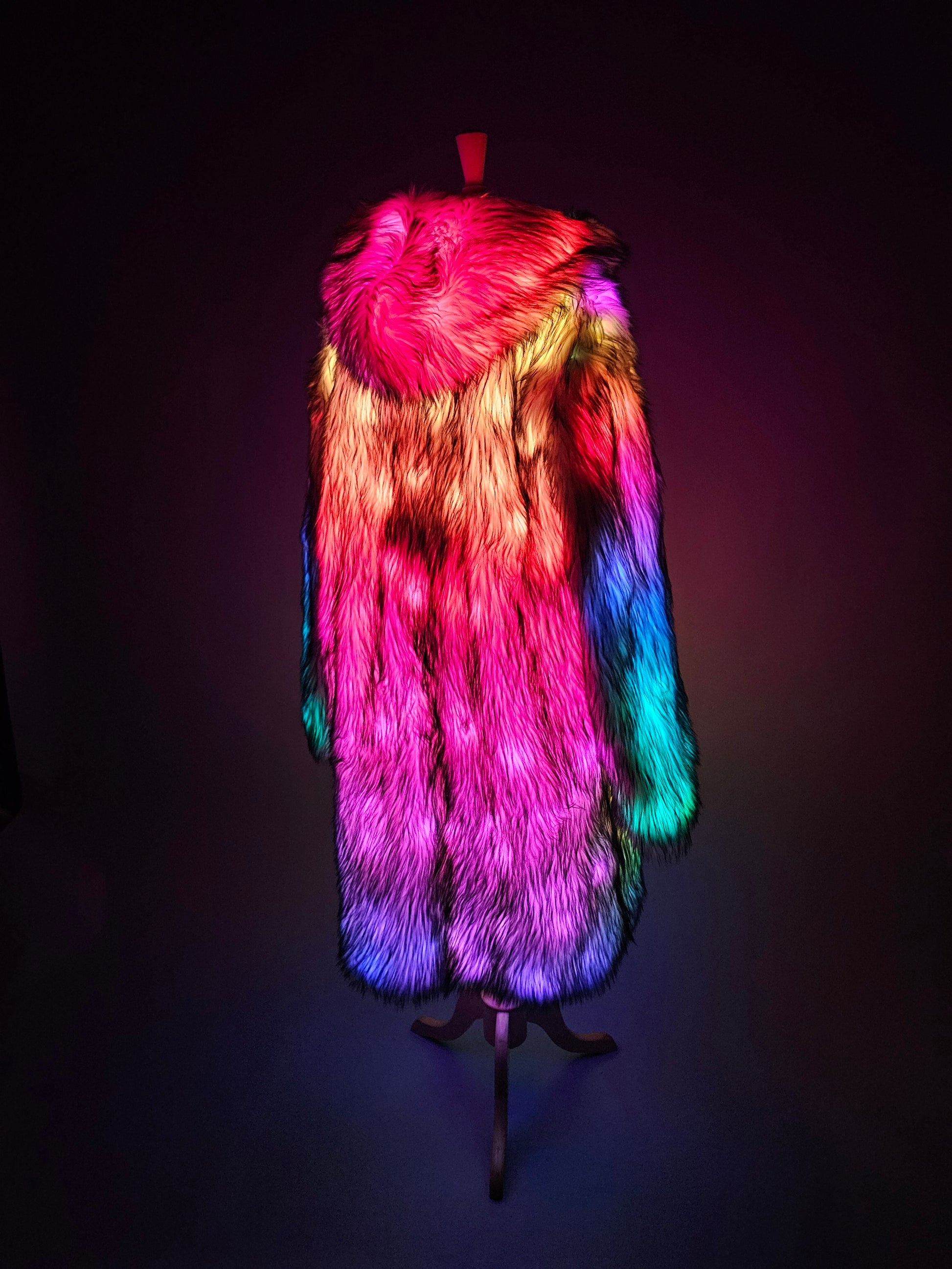 Long masculine fur coat illuminated with colorful LEDs.