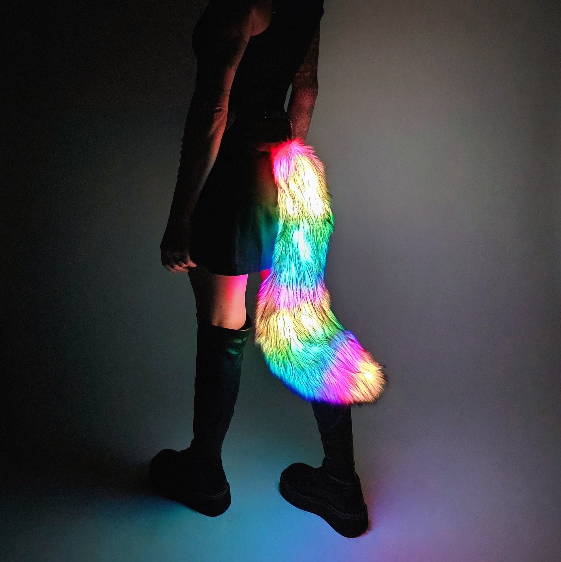 Person wearing medium LED faux fur tail with rainbow lights