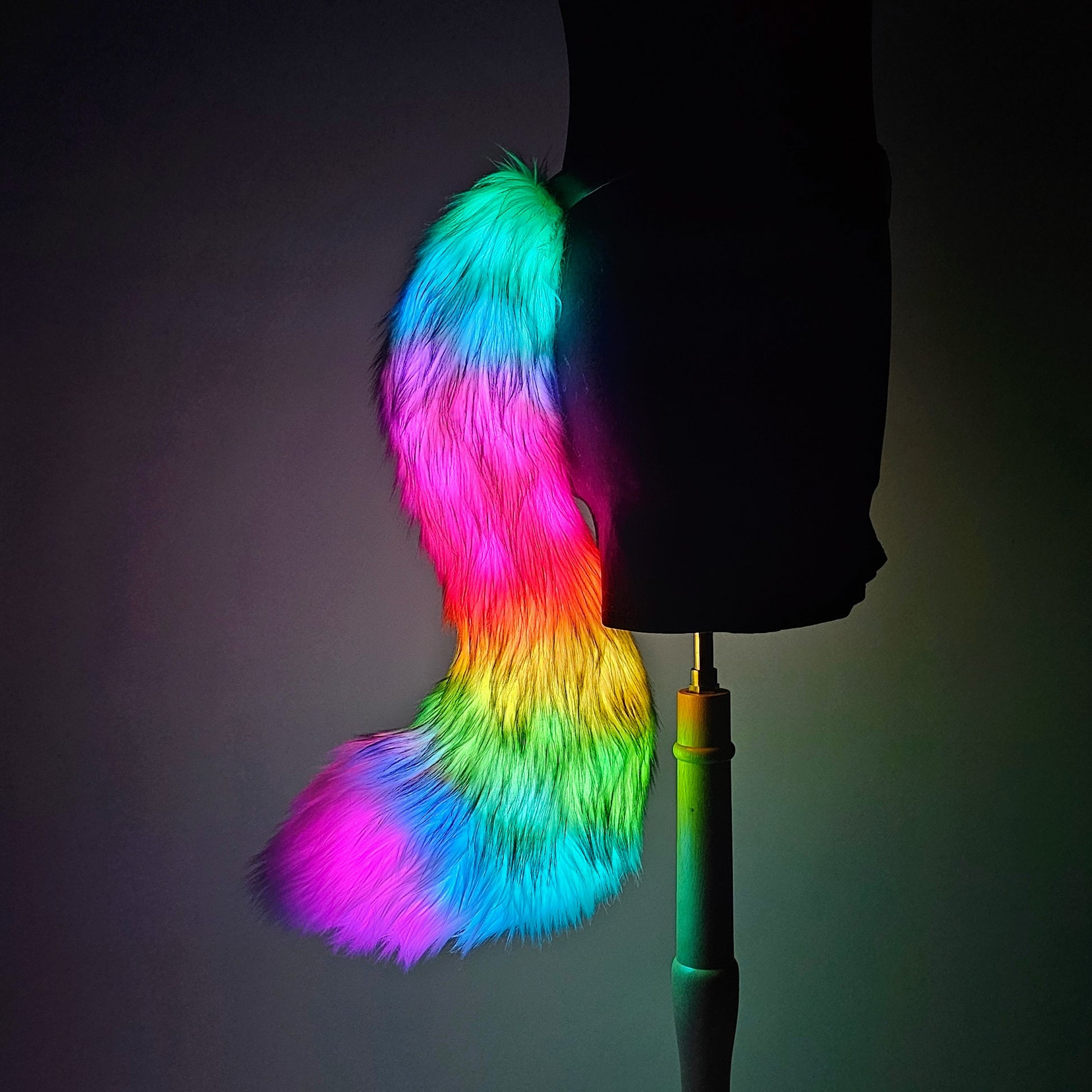 Mannequin wearing a multicolored faux fur tail with programmable LED lights, attached to a belt.
