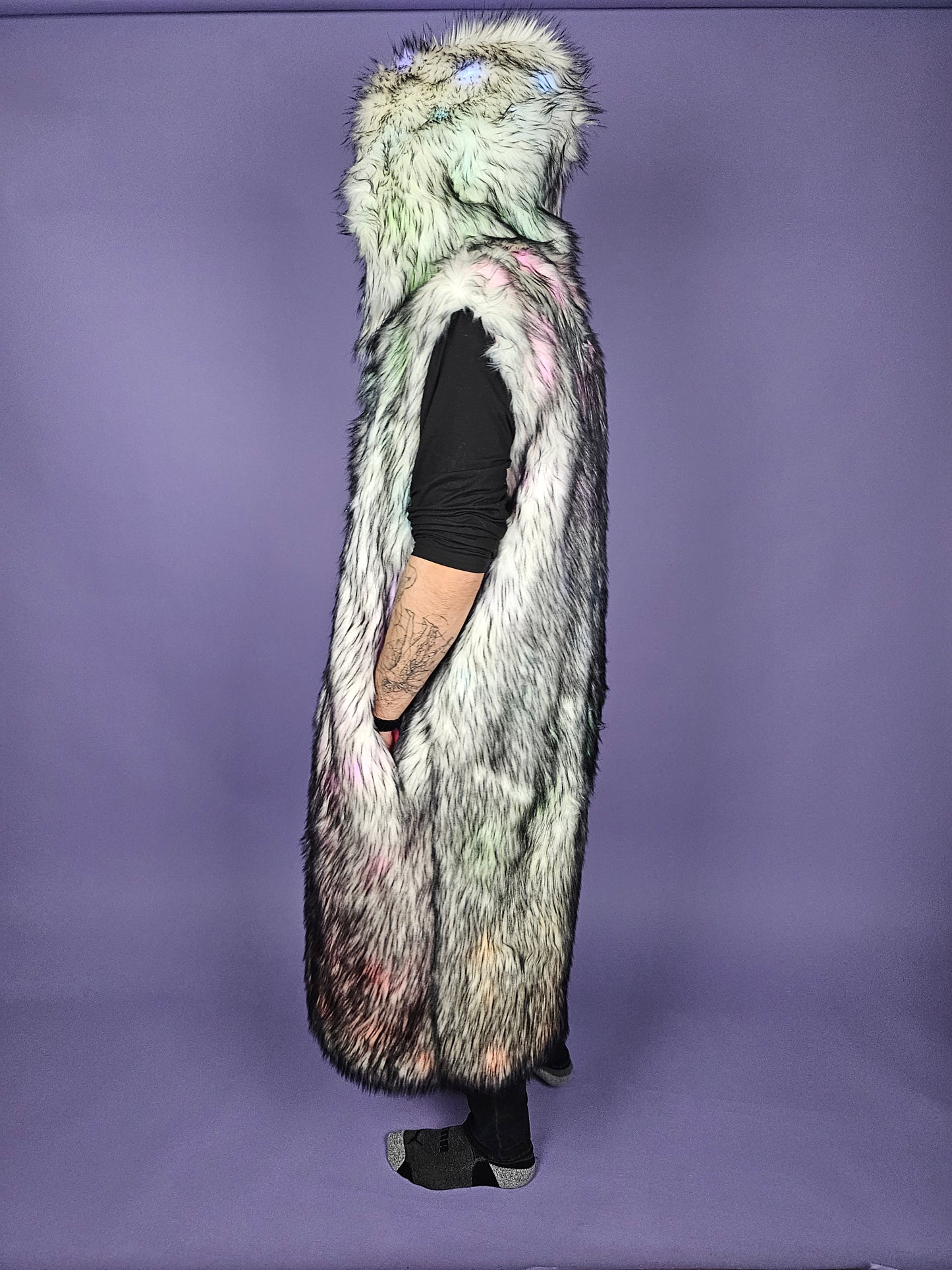 Man wearing a long gray faux fur vest.