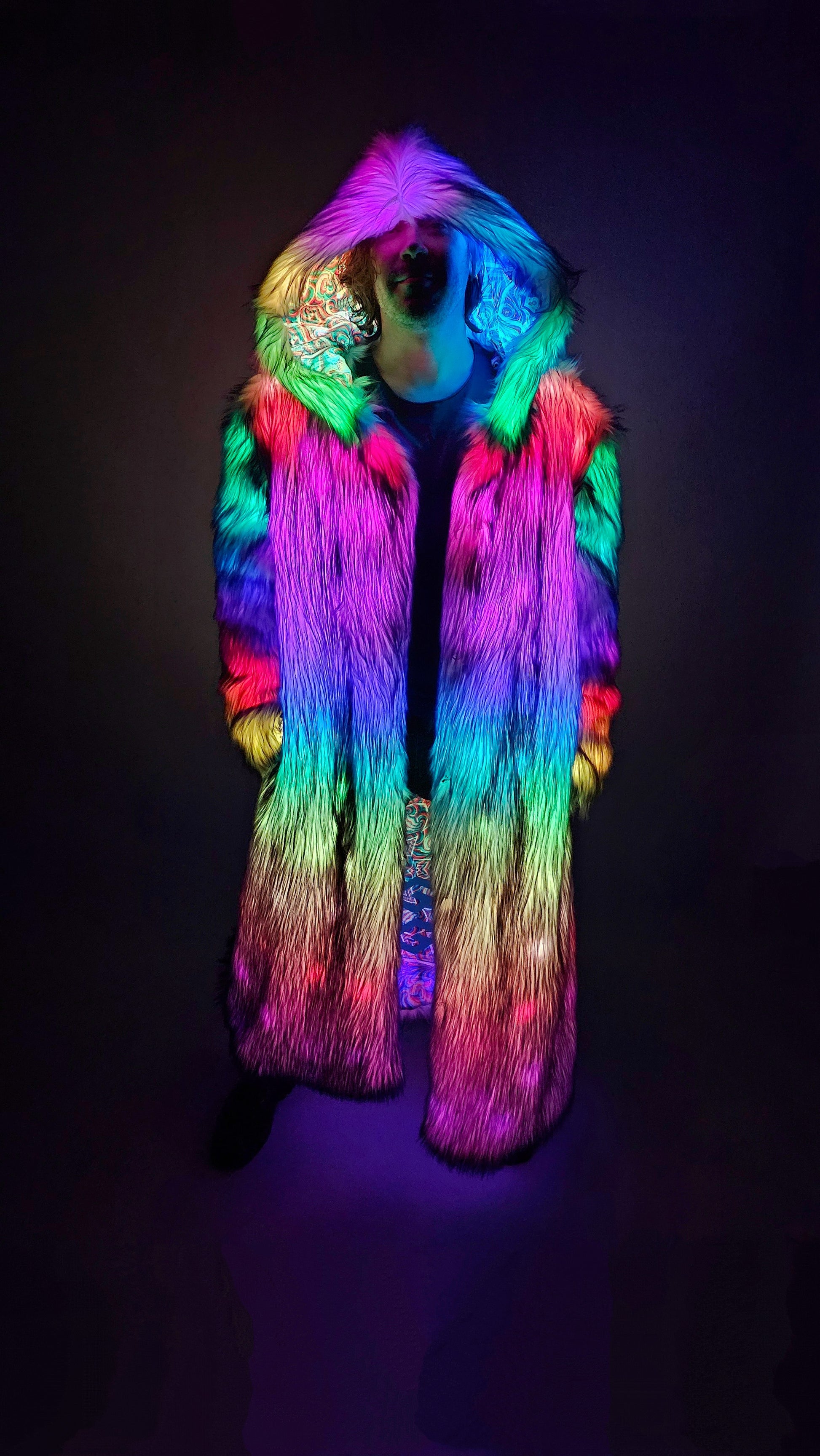 Man wearing a long faux fur coat with multicolor LEDS.