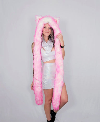 Person wearing a long pink cat ear hood on a plain background