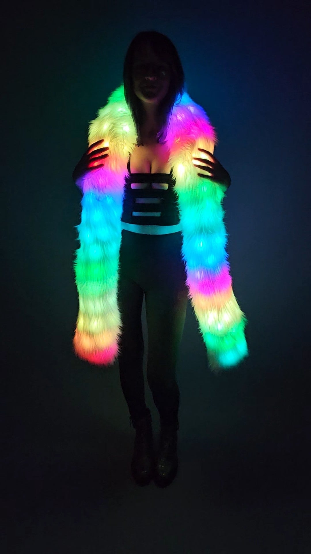 Woman wearing a white faux fur Glow Worm scarf with multicolor LEDs.