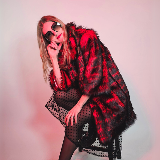 Woman wearing a red and black faux fur coat