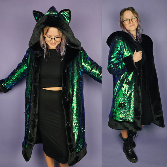 Woman wearing coat made with emerald green sequins, black faux fur trim and lining, and animal ears on the hood.