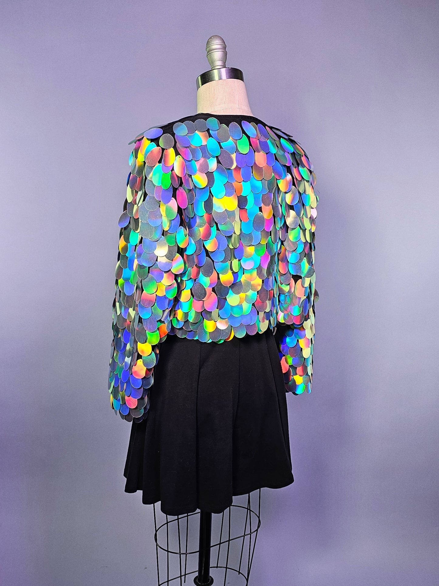 Cropped sequin jacket made with iridescent silver sequins and black satin lining