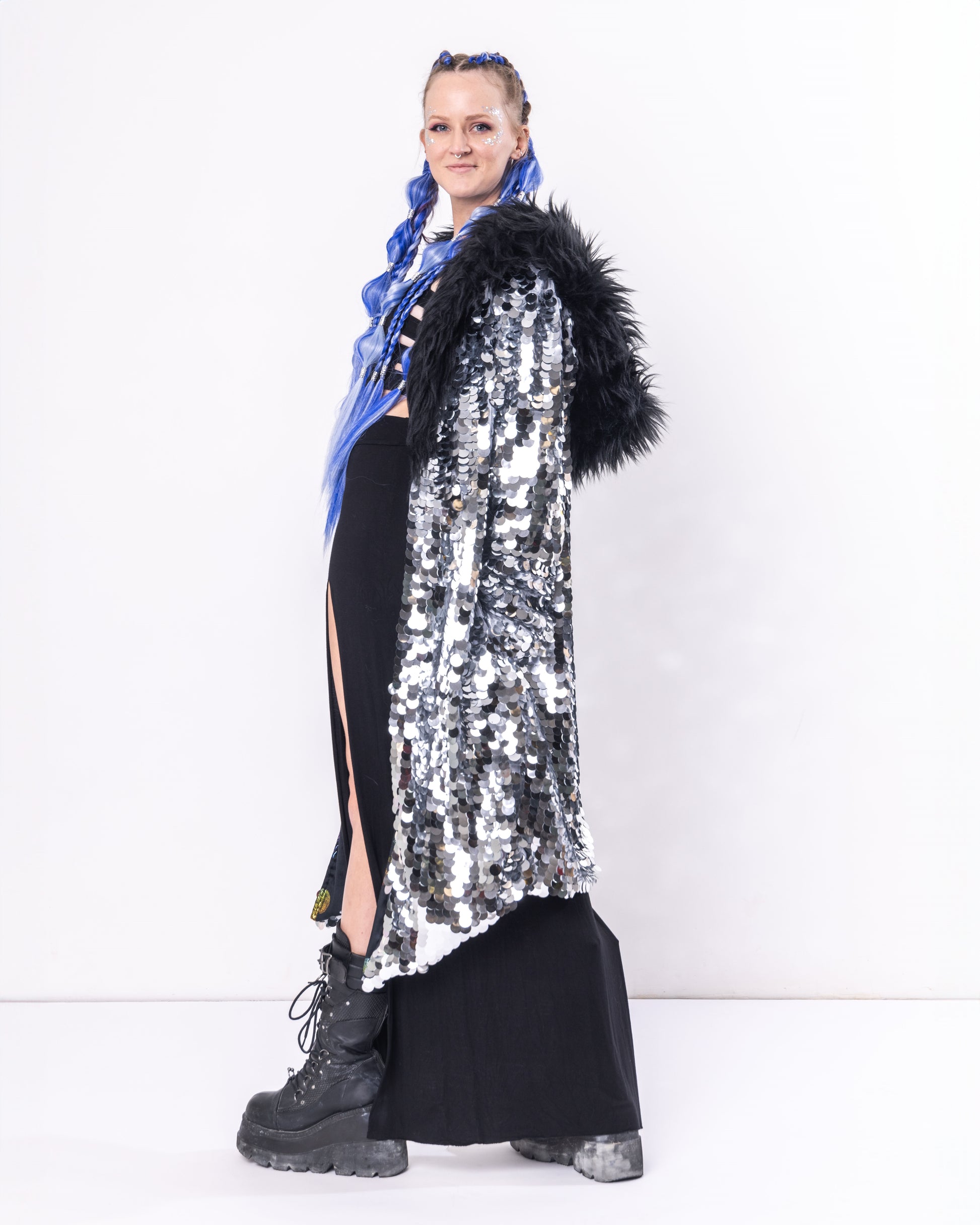 Long coat made with silver sequins and black faux fur trim.