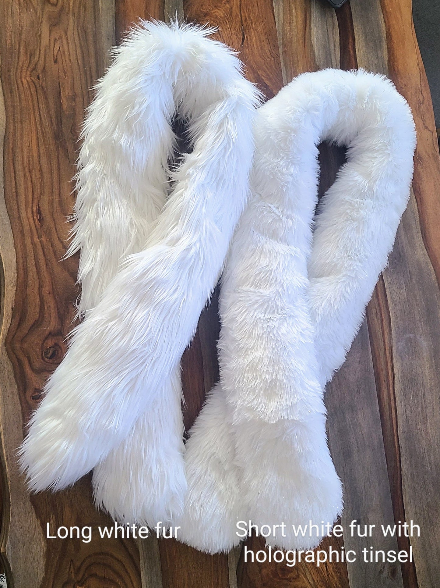 Two faux fur Glow Worm scarves, one with longer white faux fur and one with shorter white fur with tinsel.