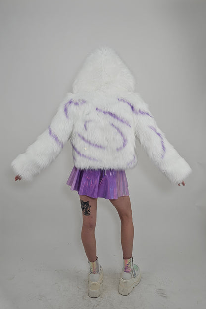 Model wearing white faux fur coat and lavender outfit