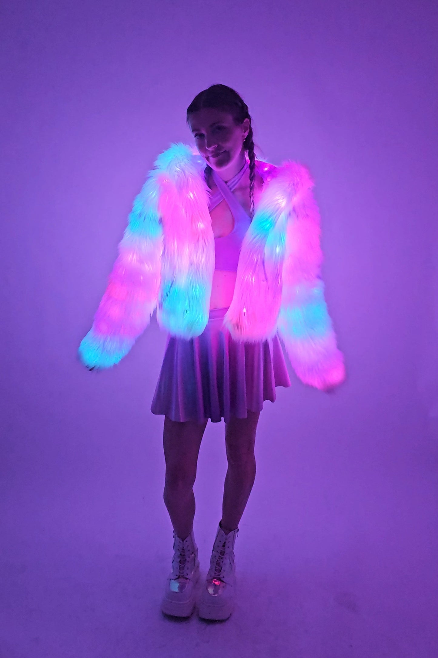 model wearing white LED coat illuminated with LEDs