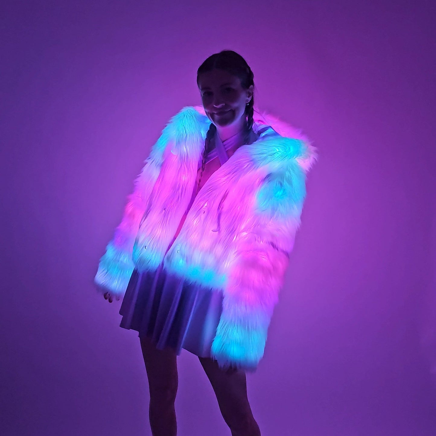 Model wearing white faux fur coat and lavender outfit