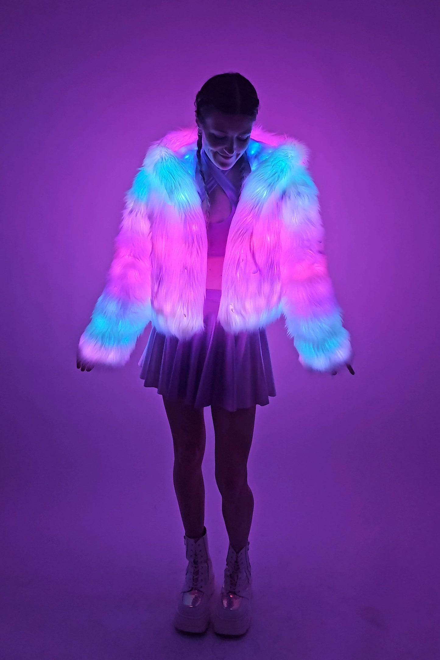 Model wearing white faux fur coat and lavender outfit