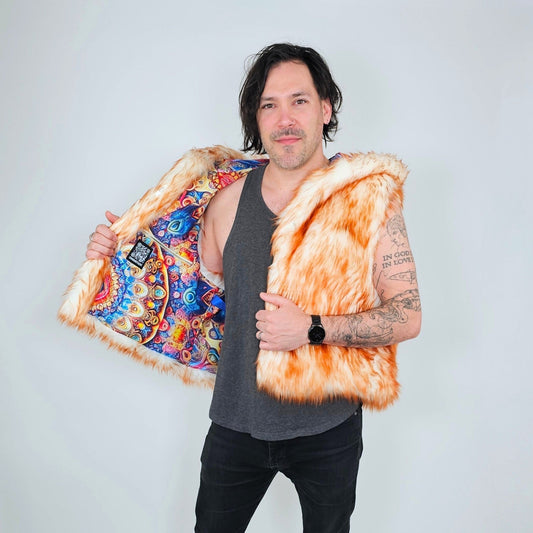 A man wearing a bright orange faux fur vest with a colorful paisley-patterned lining, holding the vest open to show the interior against a light gray background.